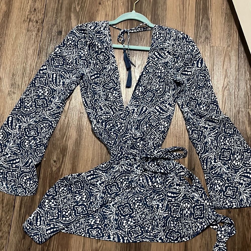 Super cute and sexy wrap dress. Low front and low back. Never worn. Size small